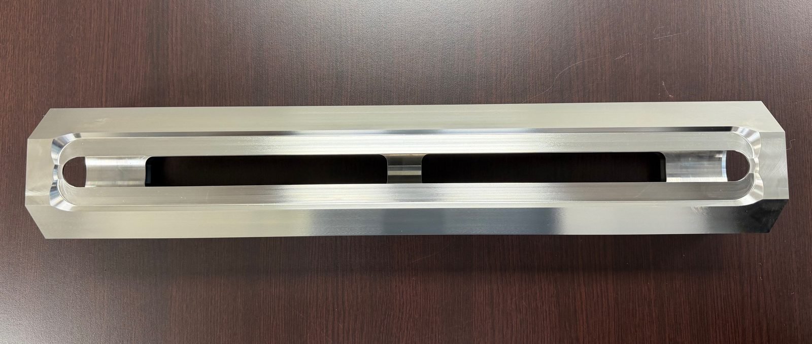 Machined aluminum fixture bar with dual elongated slot cutouts